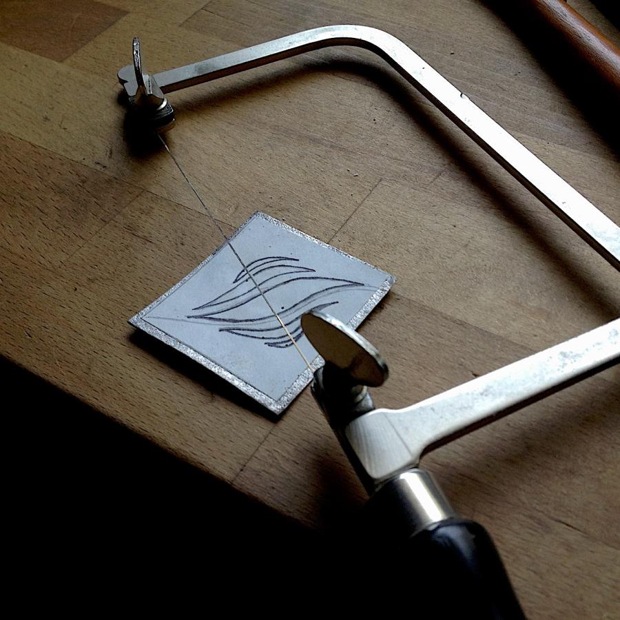 Pilot holes for sawing were punched using a nail and hammer.