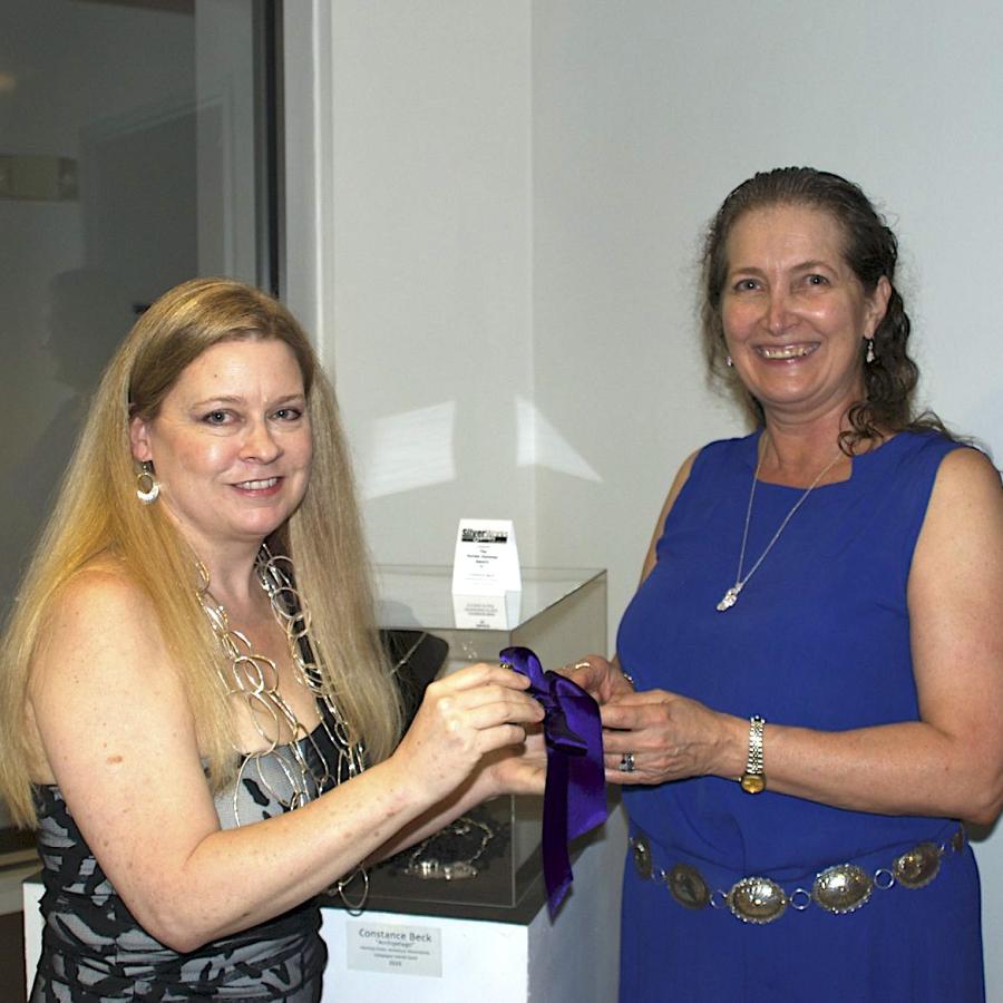 Constance Beck being presented with Purple hammer award by Blair
