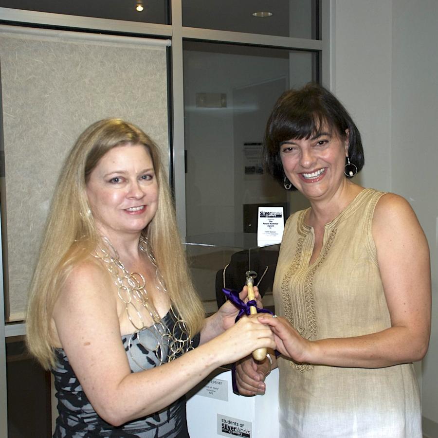 Elaine Speiser being presented with purple hammer award by Blair