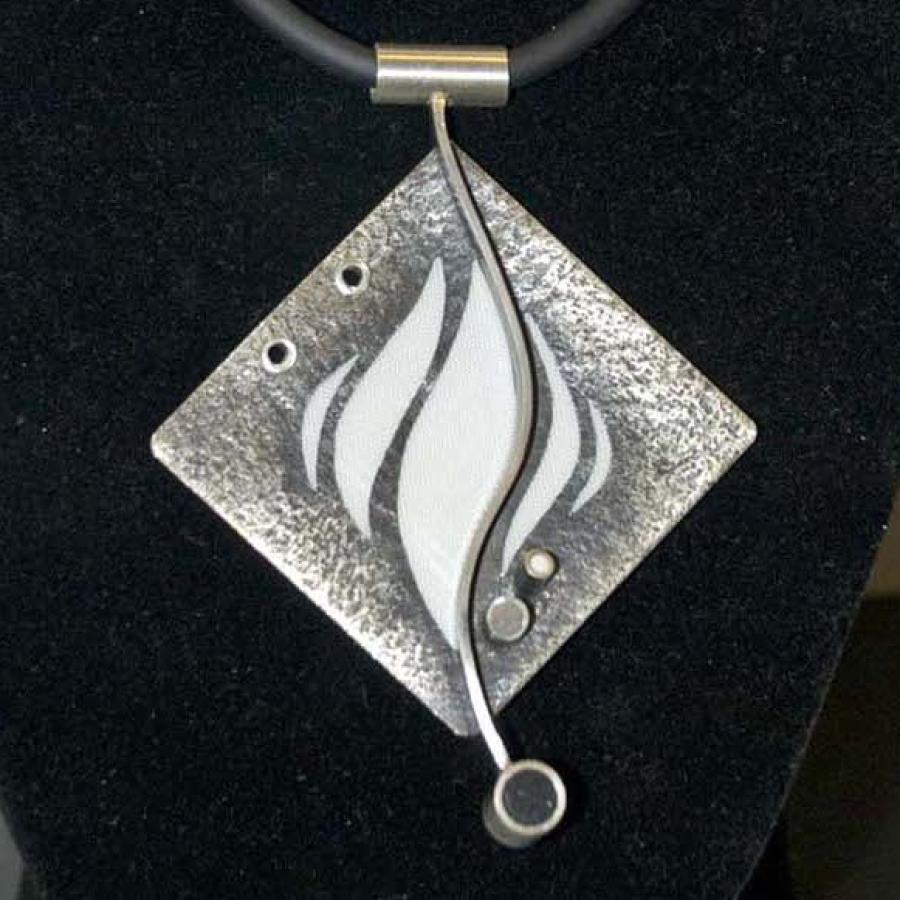 Textured diamond shaped silver pendant with white flames