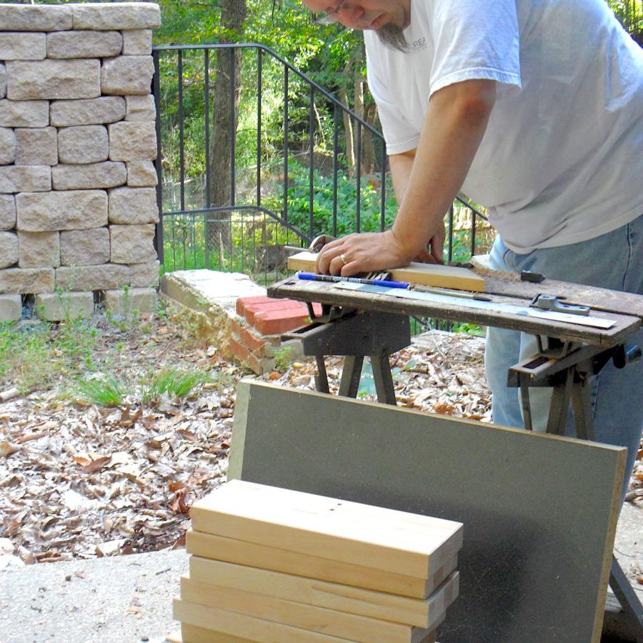 Bryan sawing out support planks for forming stakes