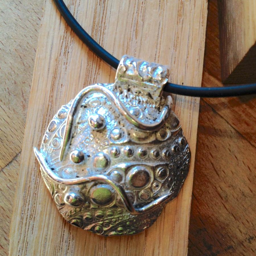 Student PMC pendant with wire and small circle designs