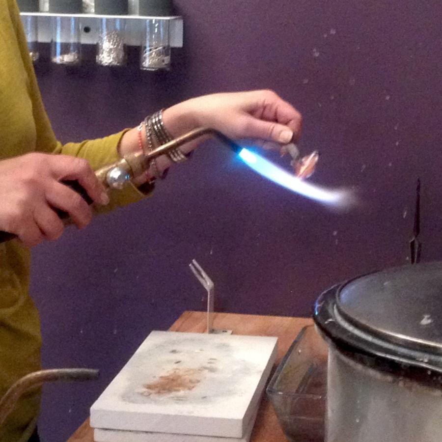 Here is a student adding a patina to the copper with the torch.