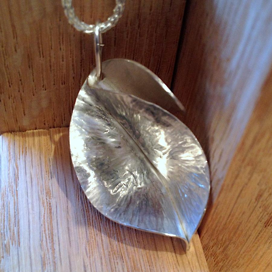 A silver Fold-Formed leaf pendant by Joan Smith.