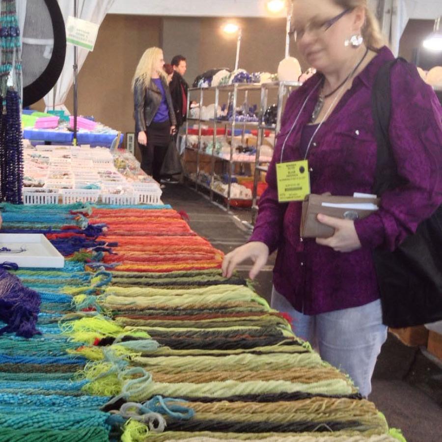 Blair looking at display of many beads