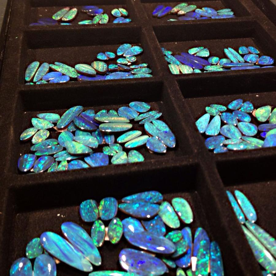 Trays of bright blue-green opals