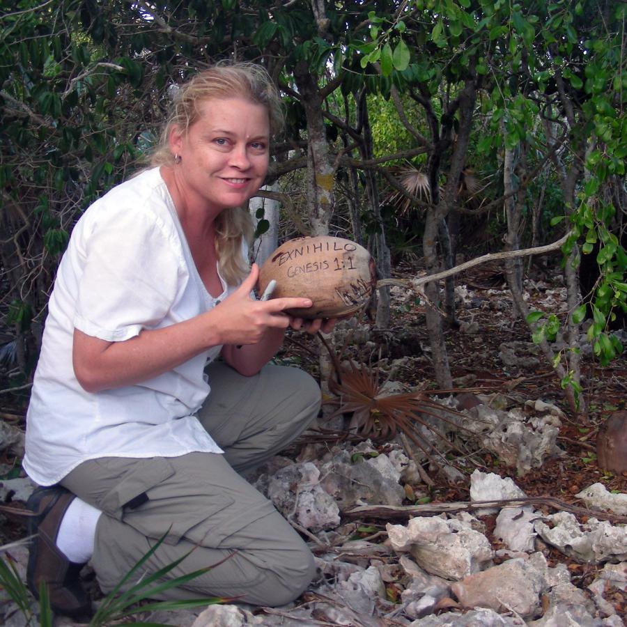 Blair planting a coconut