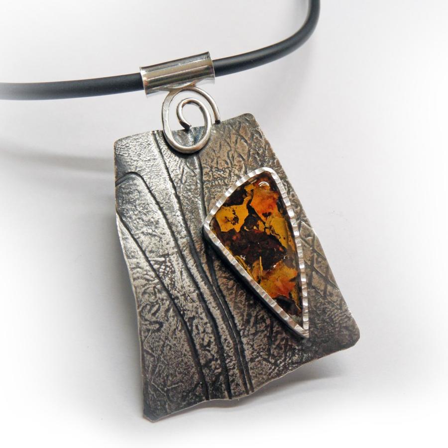 Textured silver pendant with triangular bulldozer rust in resin