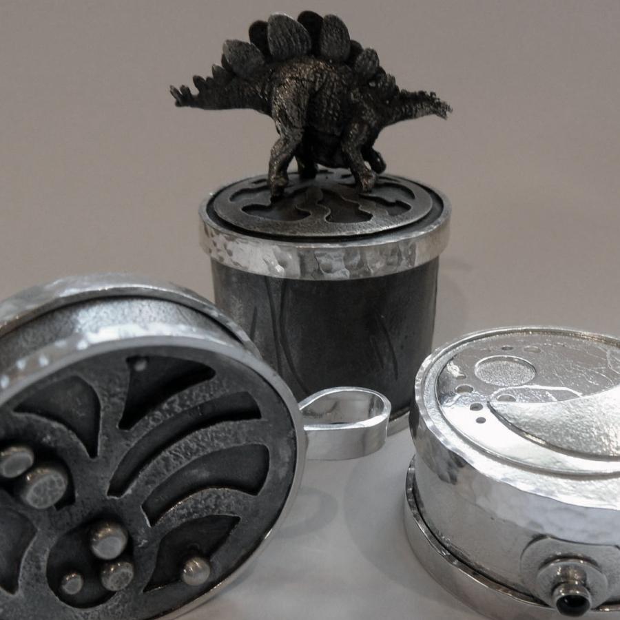 Silver boxes with cast dinosaur and other textures/layers 