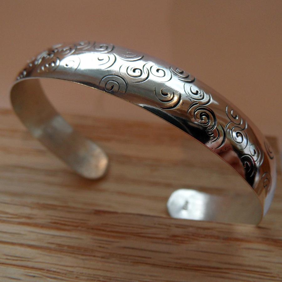 Silver bracelet with stamped swirls