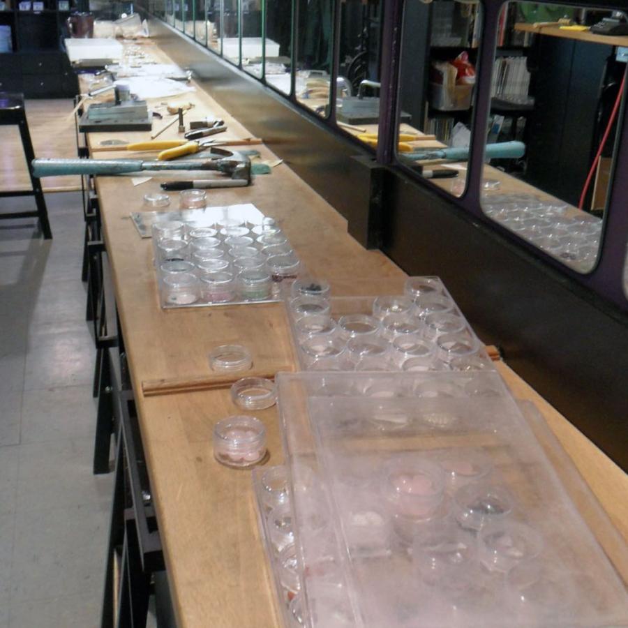 tools on bench next to box of pink stones