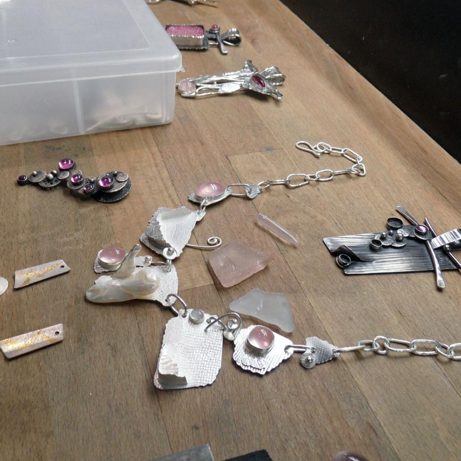 Works in various stages of finishing laid out on bench