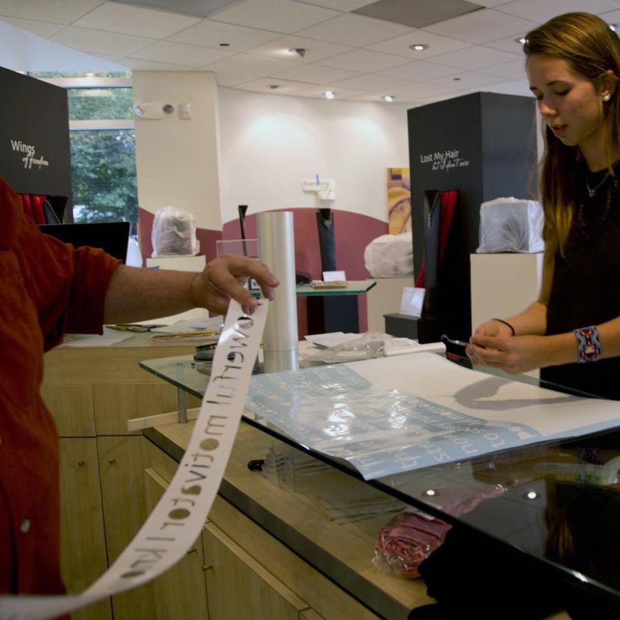 Bryant and Kaila weeding the vinyl text