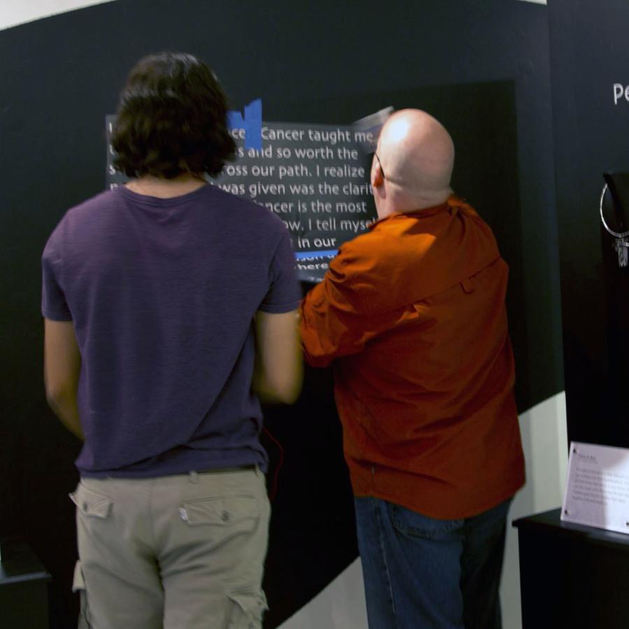 David and Bryan installing vinyl text on the wall