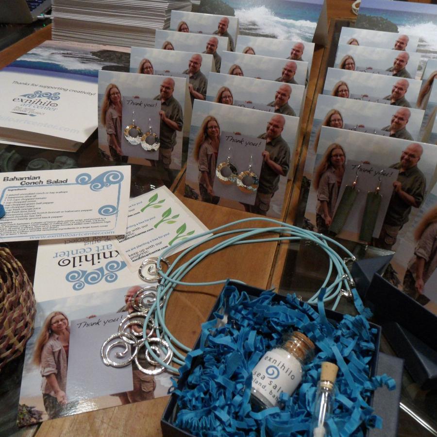 Numerous earrings lined up on cards with picture of Blair and Bryan