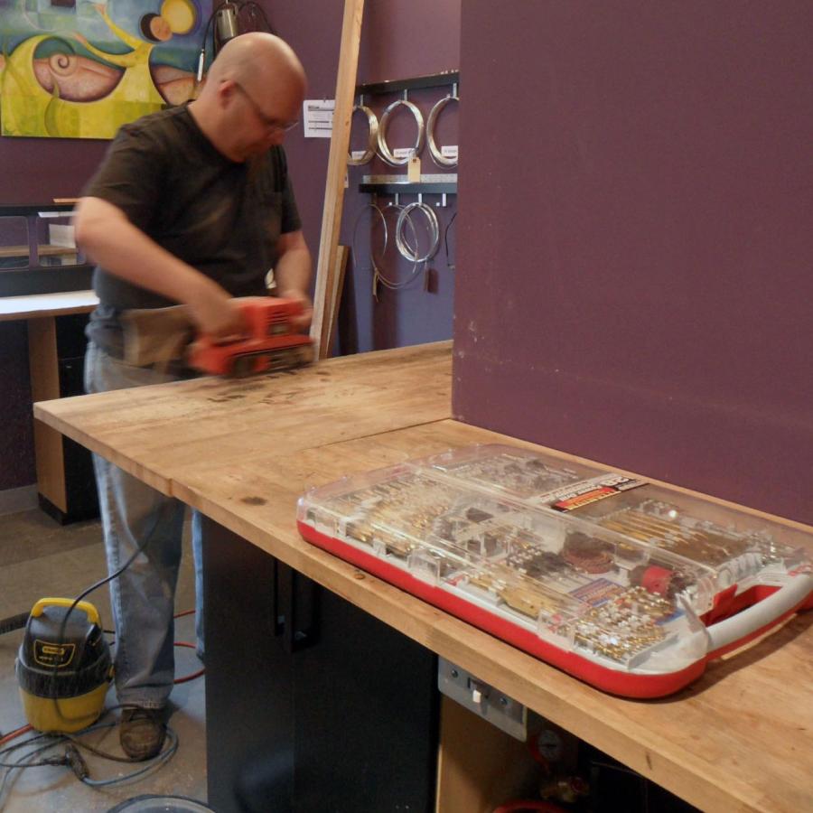 Bryan sanding down benches