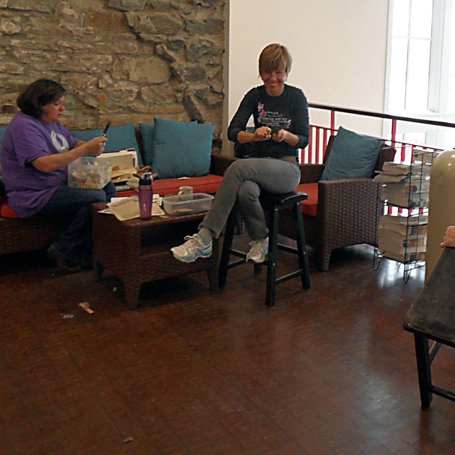 Janet, Helena, and Linda in the lobby working on different projects