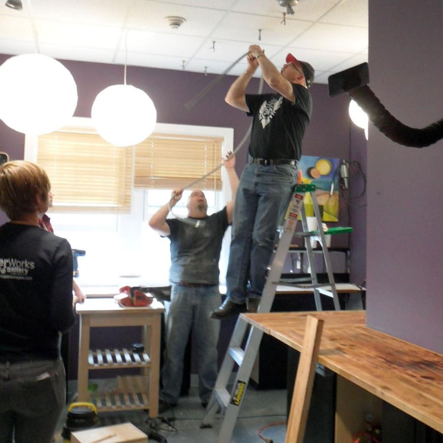 Neil on ladder installing new studio lights