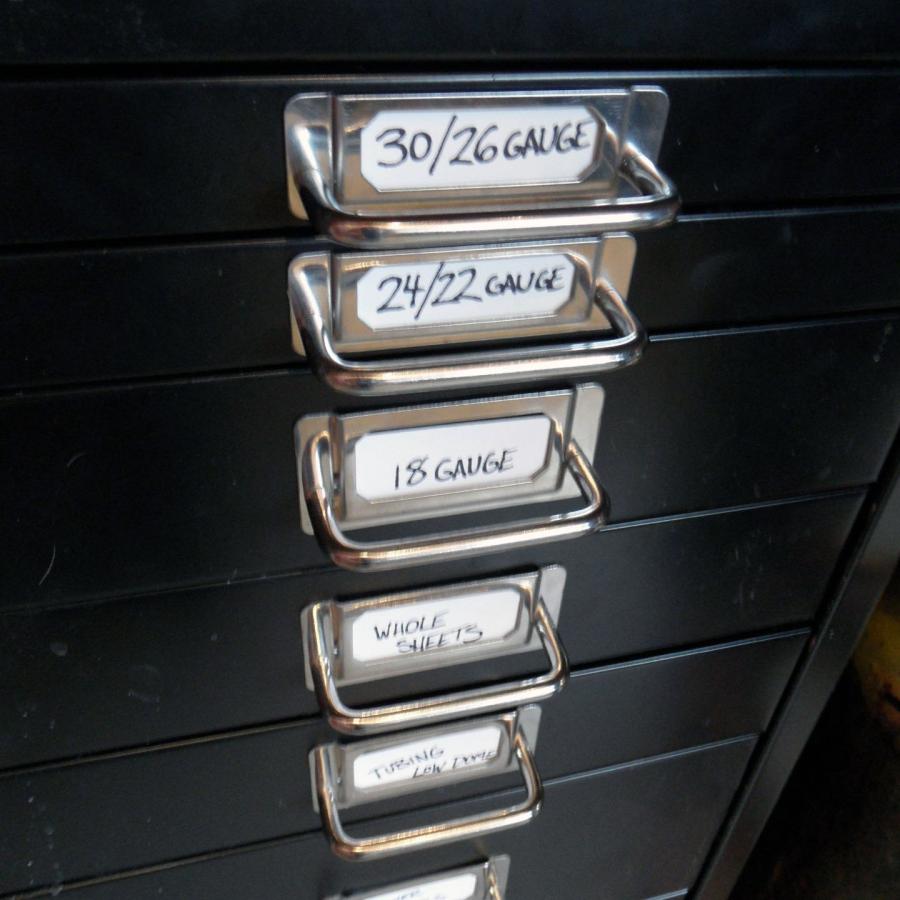 black drawers with metal handles labeled with different gauges