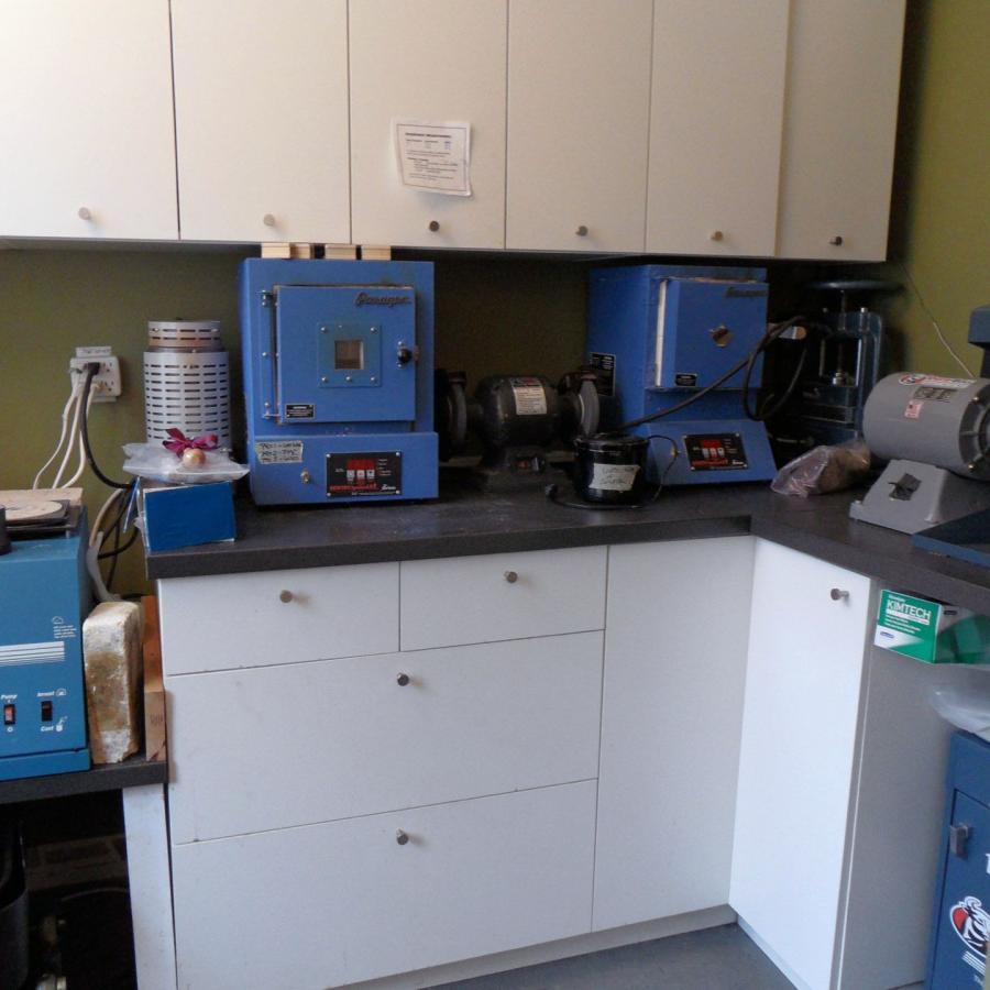corner of room showing numerous cabinets and drawers 