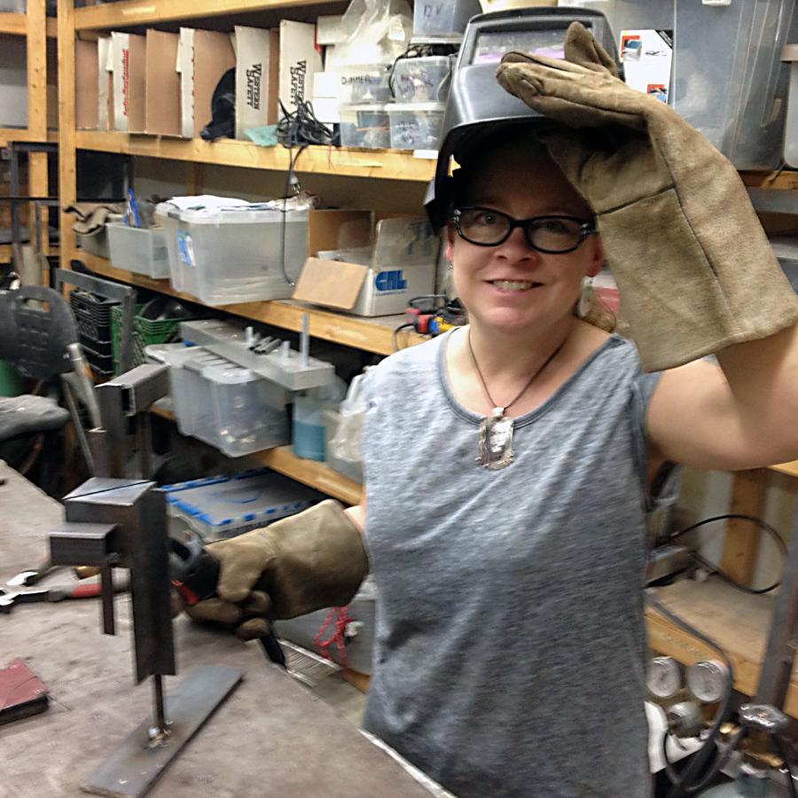 Blair holding welding visor and welder