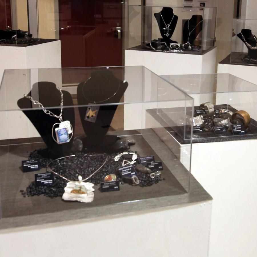 Various student works on fish rocks in display cases
