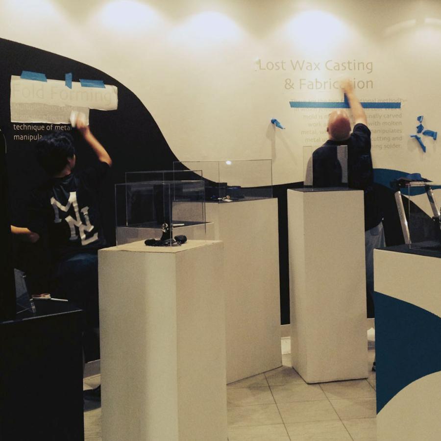 wide shot of show with more vinyl text going up