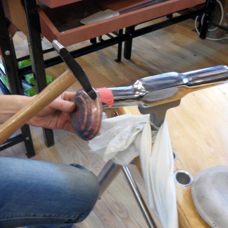 Hammering copper on steel stake