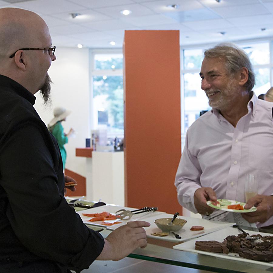 Bryan talking to patrons by the refreshments