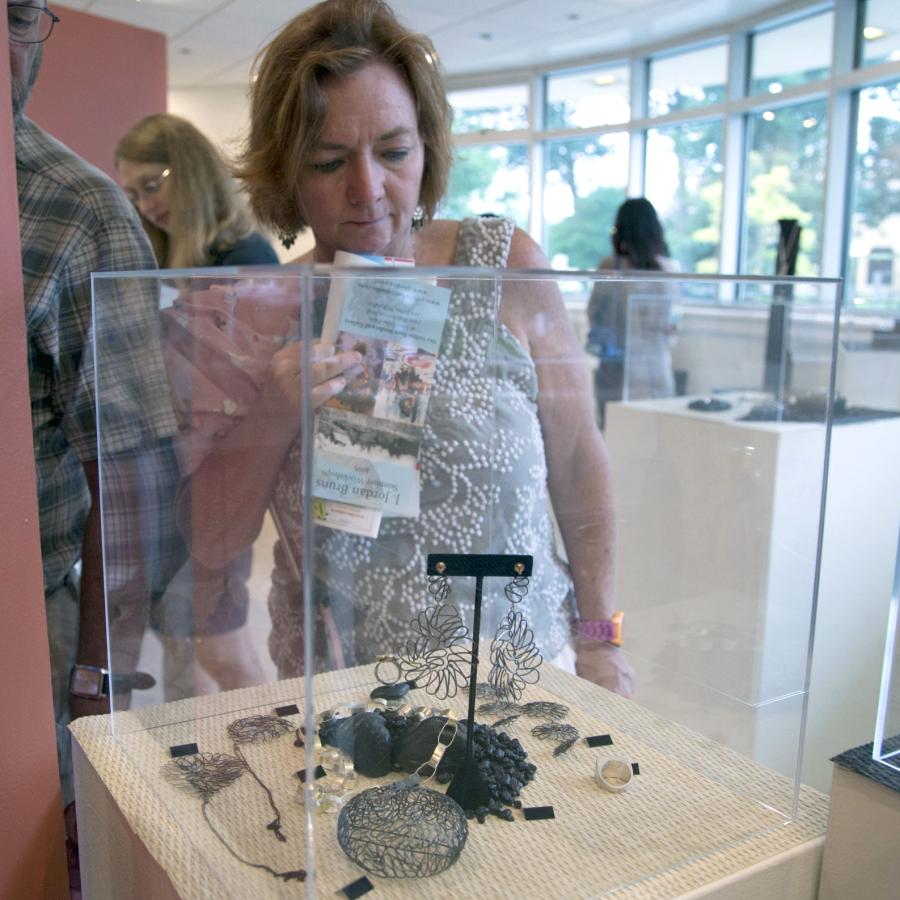 a guest viewing work in a display case