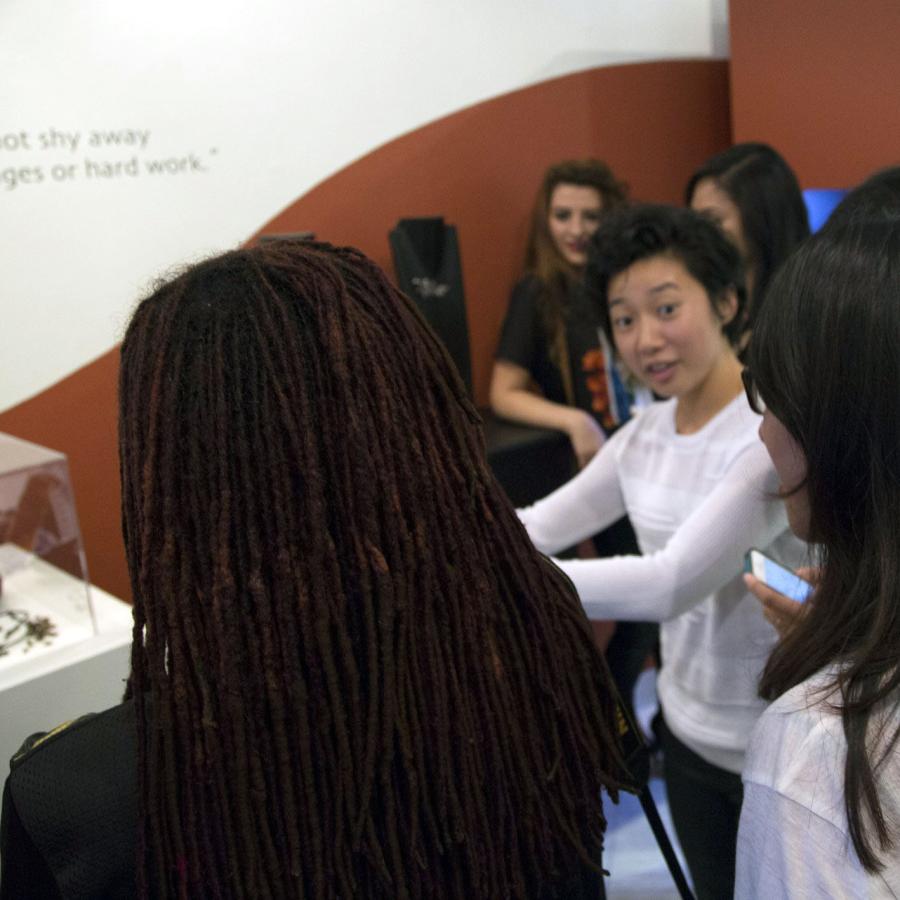 Kai talking with guests by her displayed work