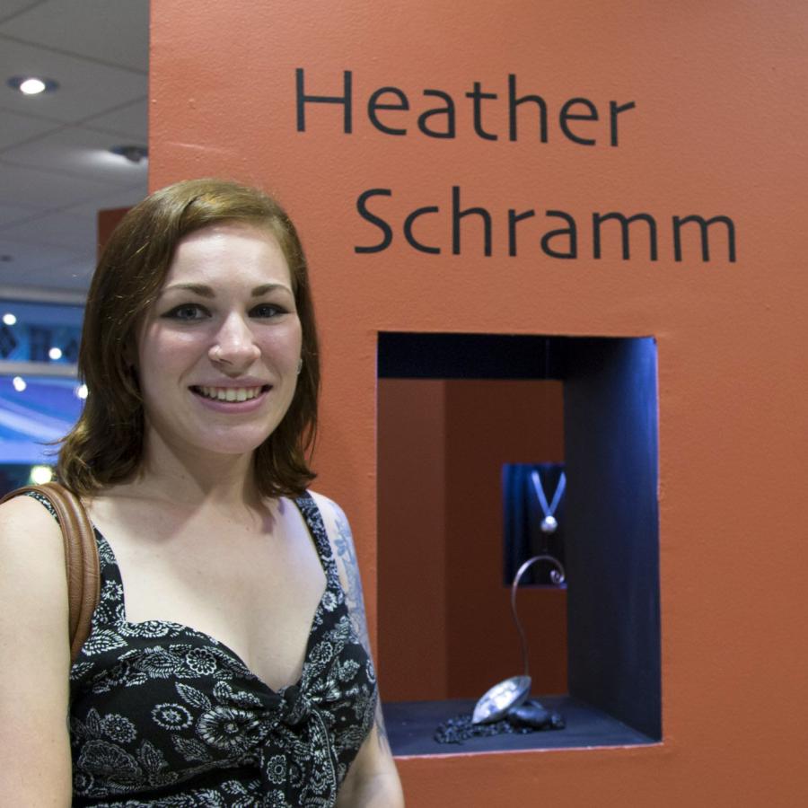 Heather standing by her tower display with name and work