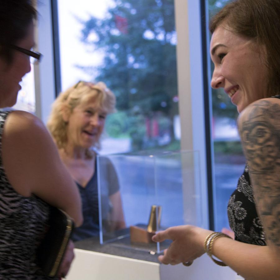 Heather talking to patrons about her displayed sculpture