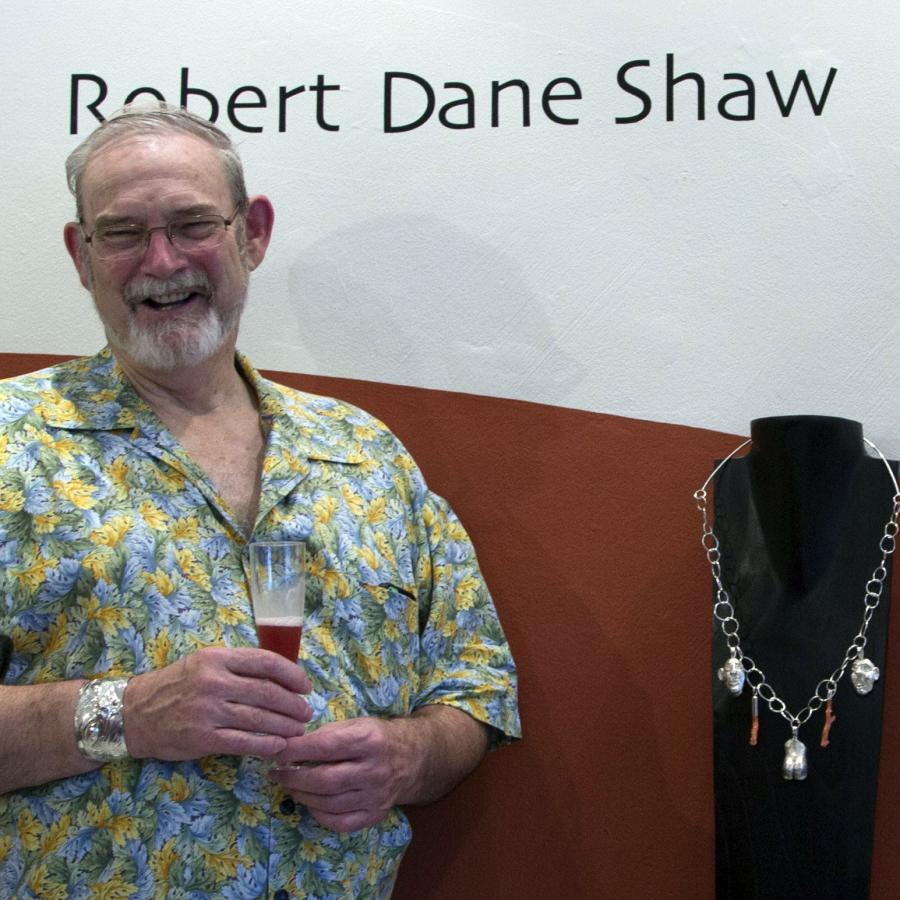 Robert standing by his name display and work