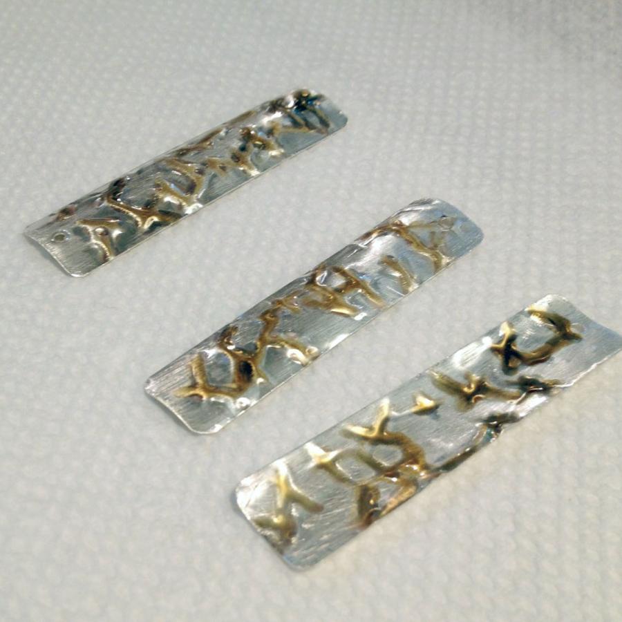 rectangular silver pieces with gold pen plating