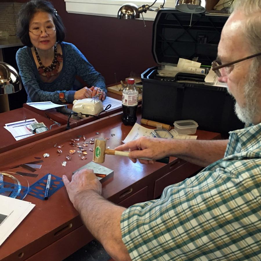Bob demos a bilateral folded leaf to students