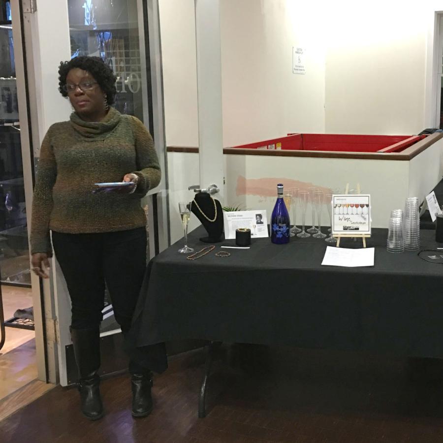 Nichelle next to a display table of her work