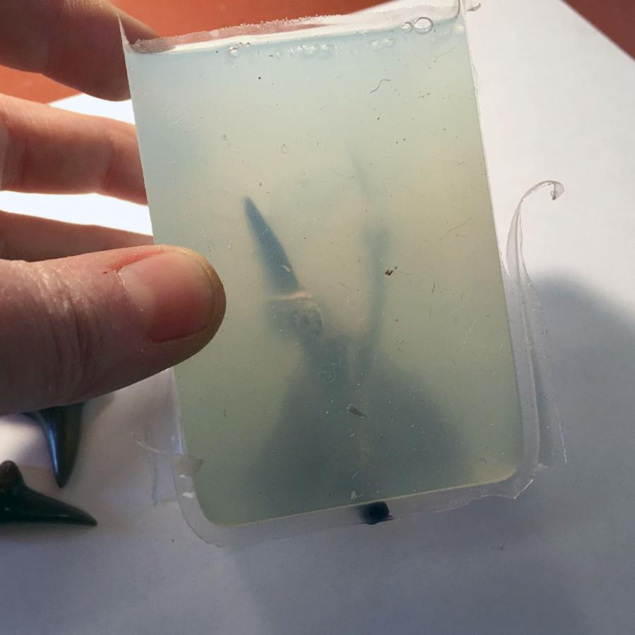 off-white silicone mold with object inside