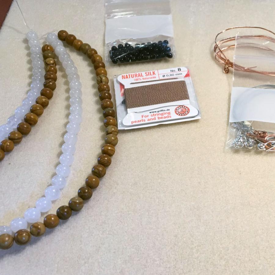 tools laid out for workshop, beads string and pliers. 