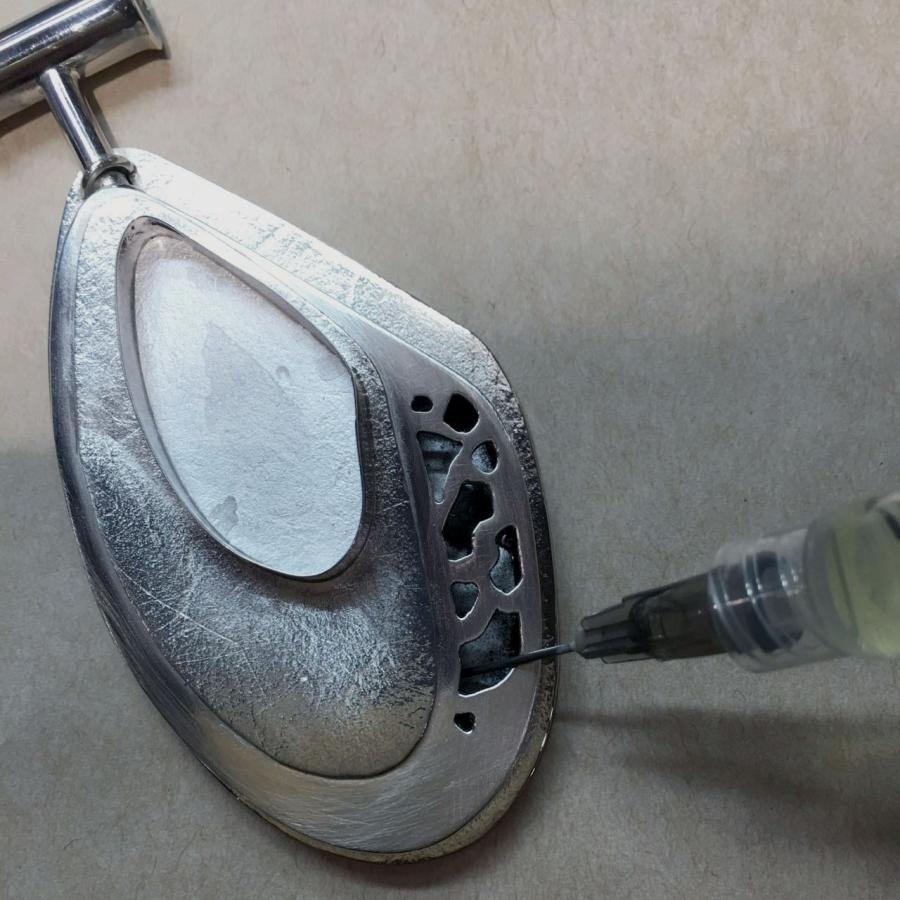 using syringe to injectthe cutout pendant with oxidizer