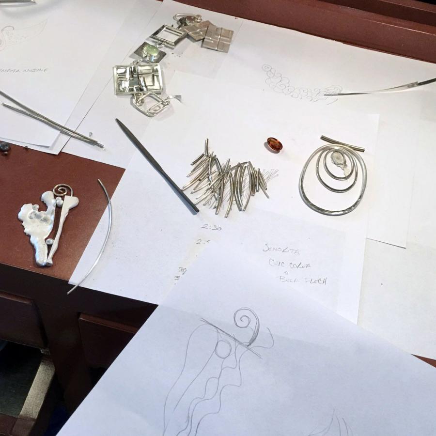 several projects in process laid out on paper with sketches