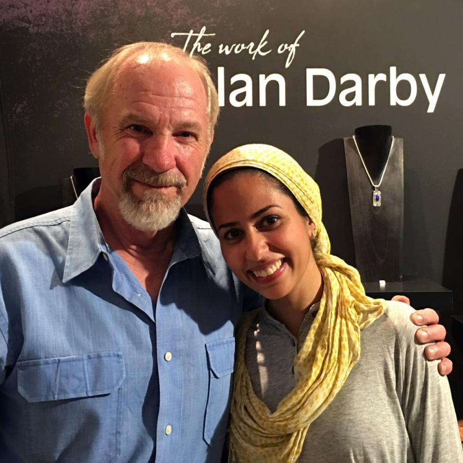 alan and mawadda posing in front of his name and work