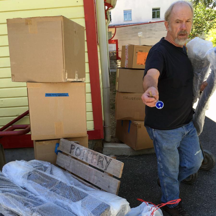 alan next to boxes and crates for show