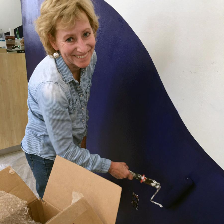 joan painting the wall blue