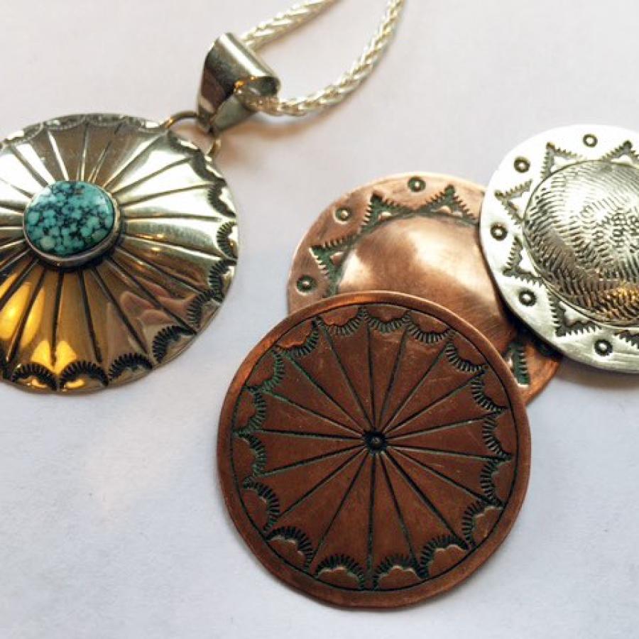 circular stamped pendants in various metals, one with turquoise in center