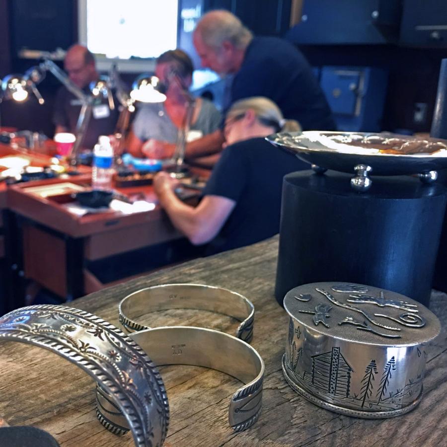 Foreground: stamped cuffs and boxes. Background: Alan Darby teaching the workshop.