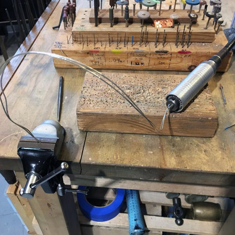 two lengths of wire with one end in flex shaft drill and the other in vice