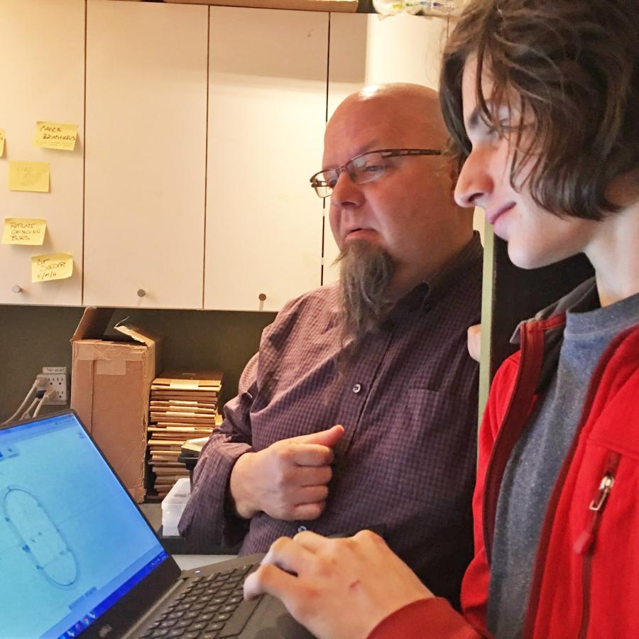 Bryan and Louis looking at computer screen with teapot shape