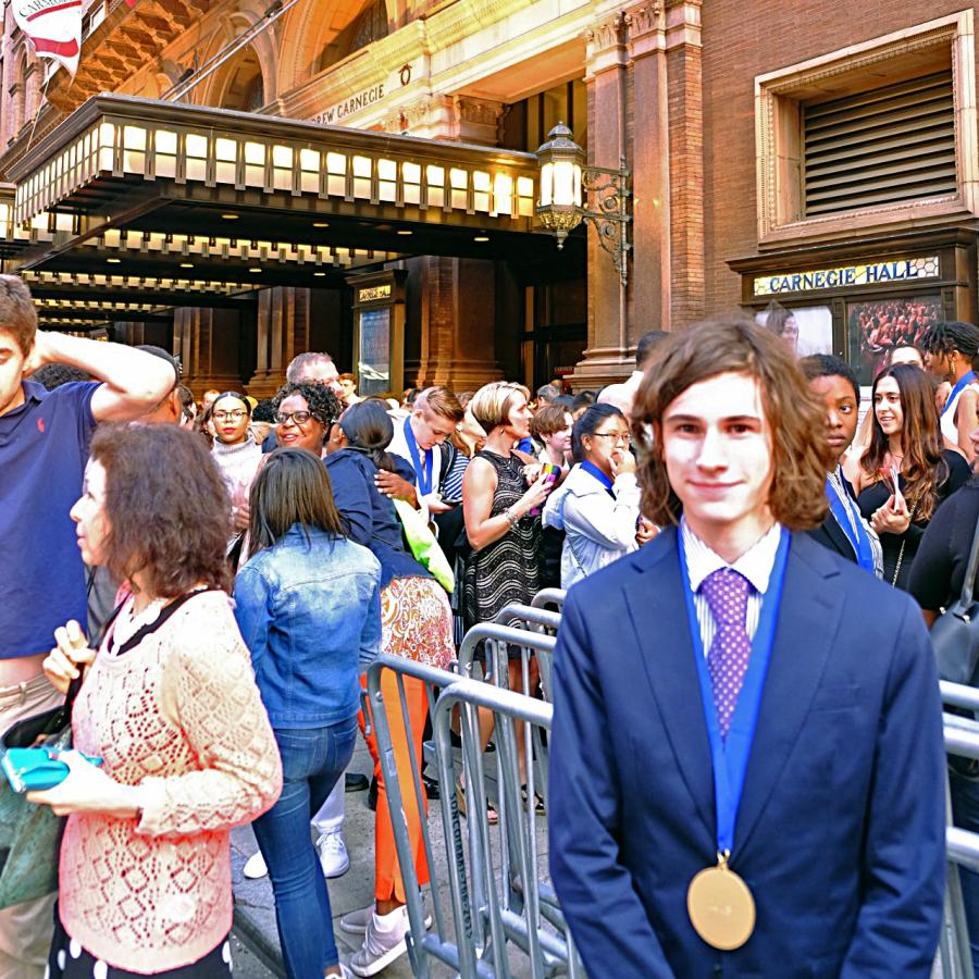 Louis in a suit in front of Carnegie Hall