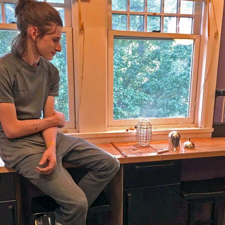 Louis looking at the disassembled parts of the teapot